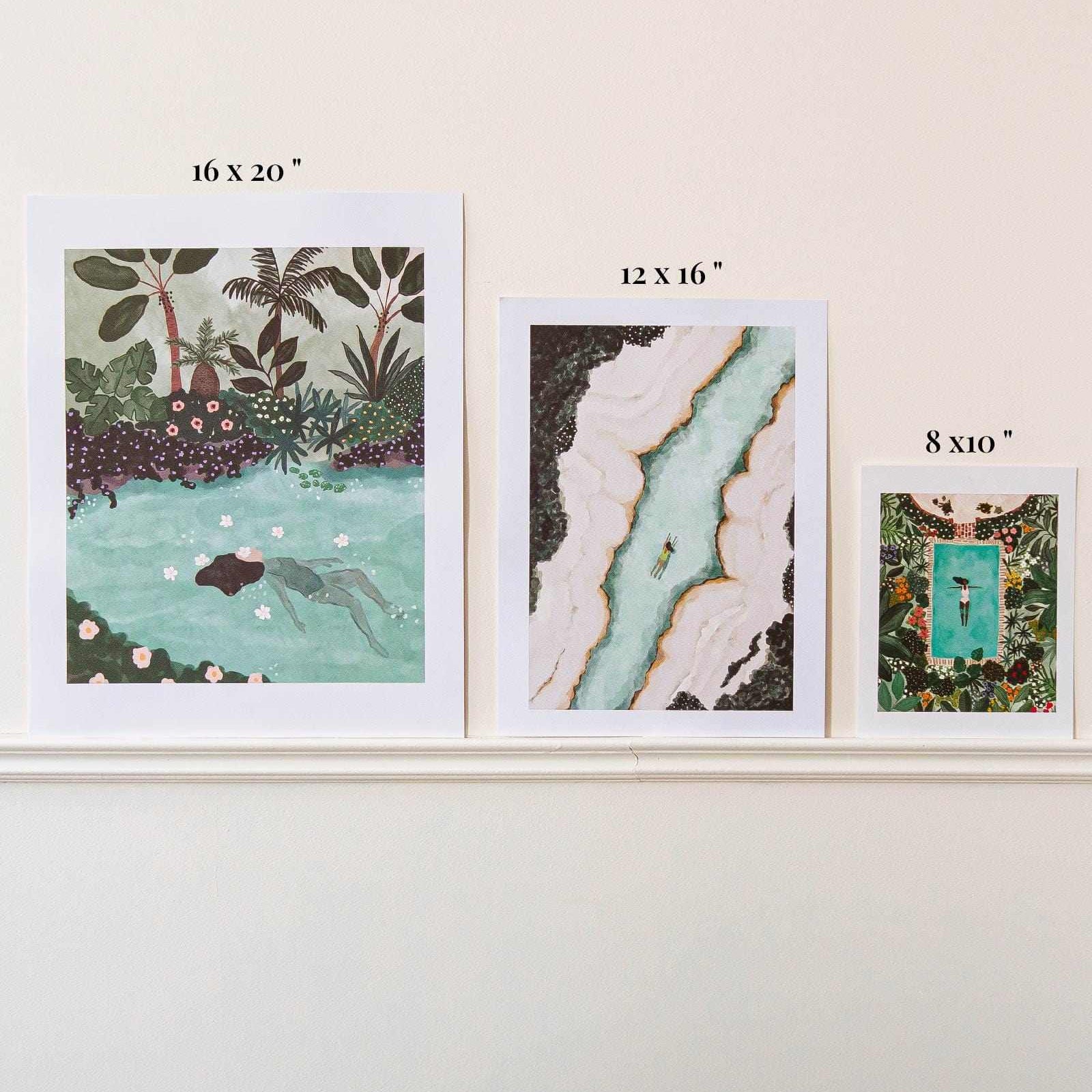 Three framed artworks of different sizes on a white wall.