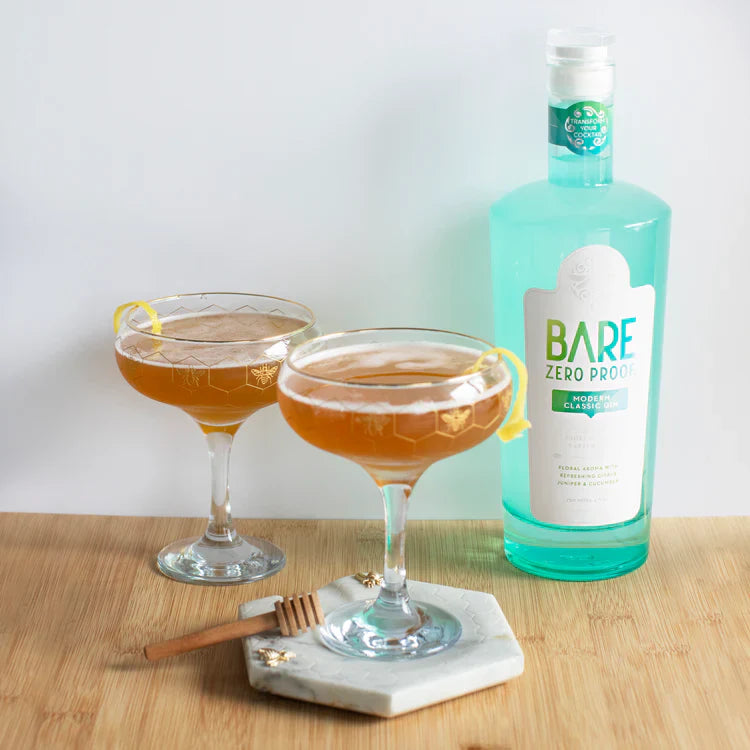 Bottle of Bare Zero Prosecco Classic with two cocktails on a wooden surface.  The Sobr Market