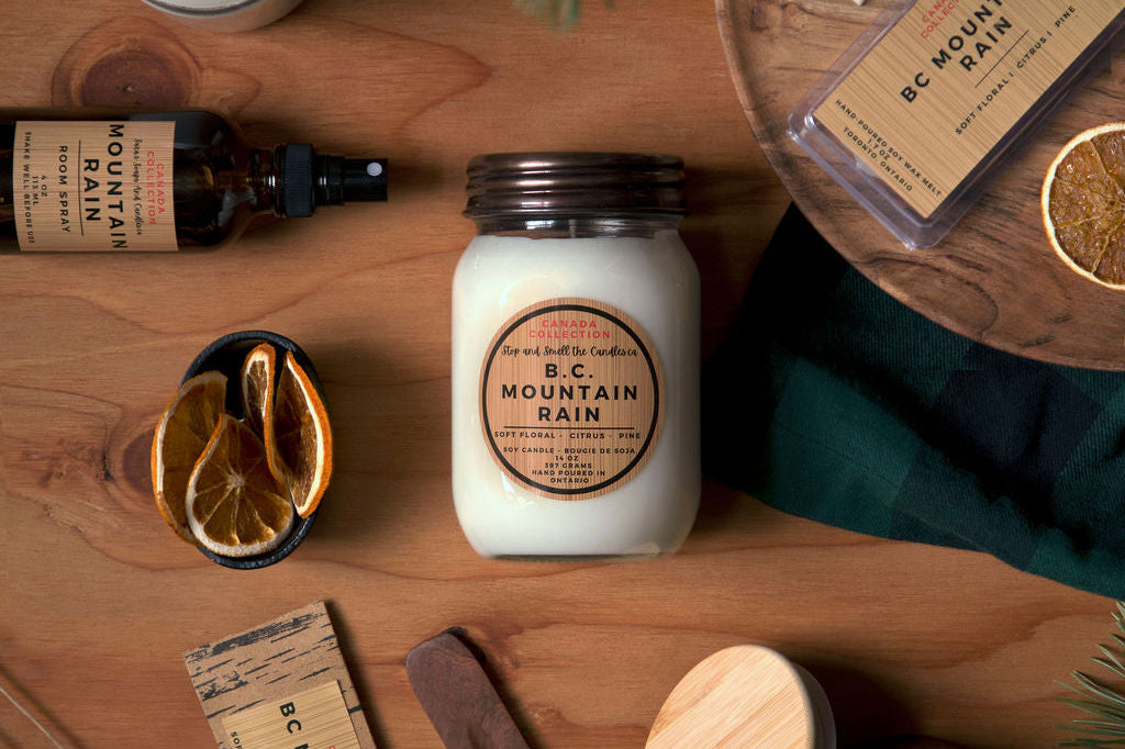 Collection of candles, soaps, and other products on a wooden surface with a natural theme.