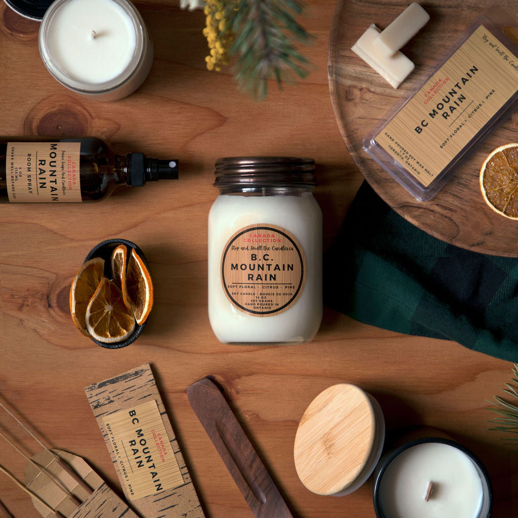 Collection of candles, soaps, and other products on a wooden surface with a natural theme.