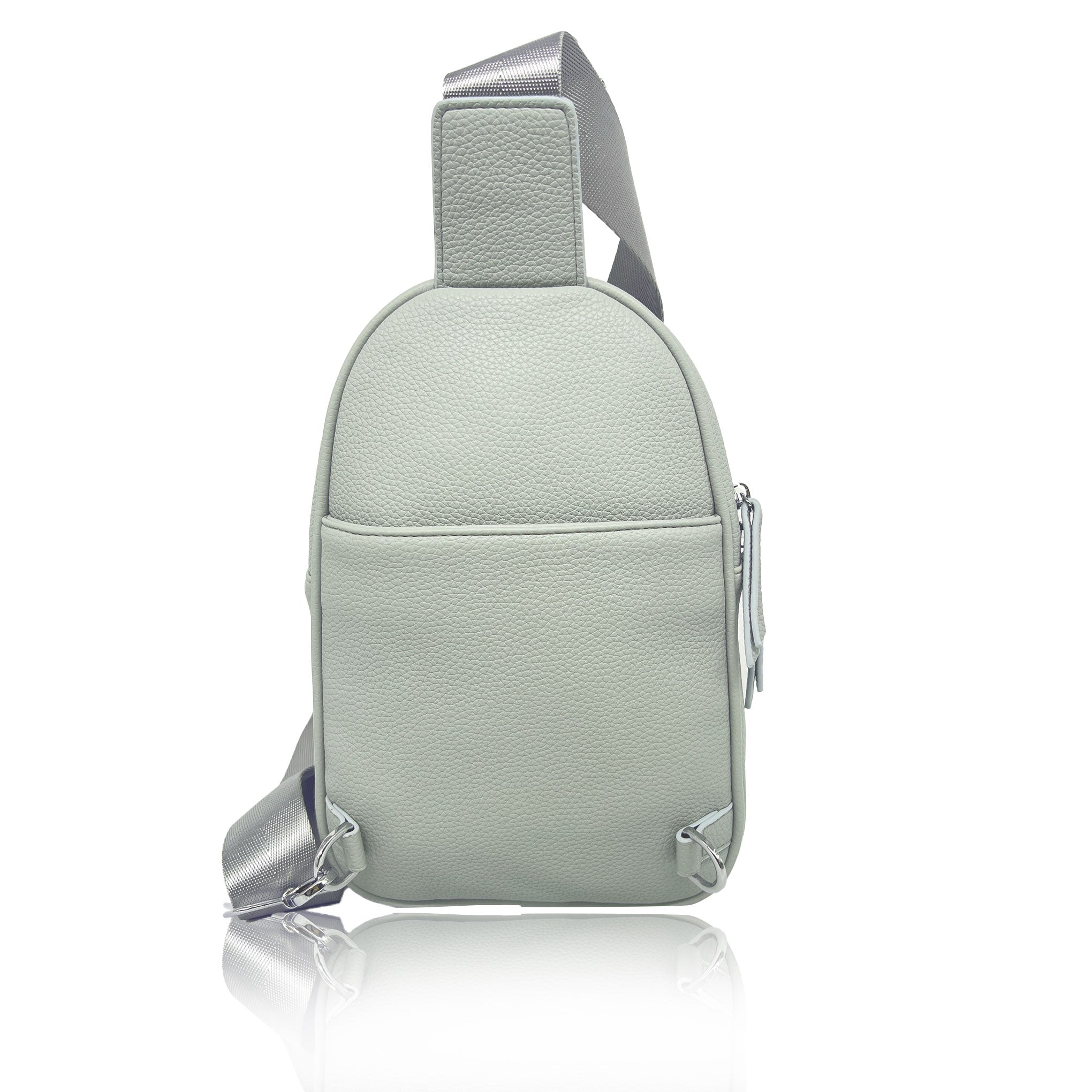 A Espe Vegan Corp light sage green pebbled leather sling bag with a silver-grey adjustable shoulder strap, shown from a three-quarters angle on a white background with a soft reflection.