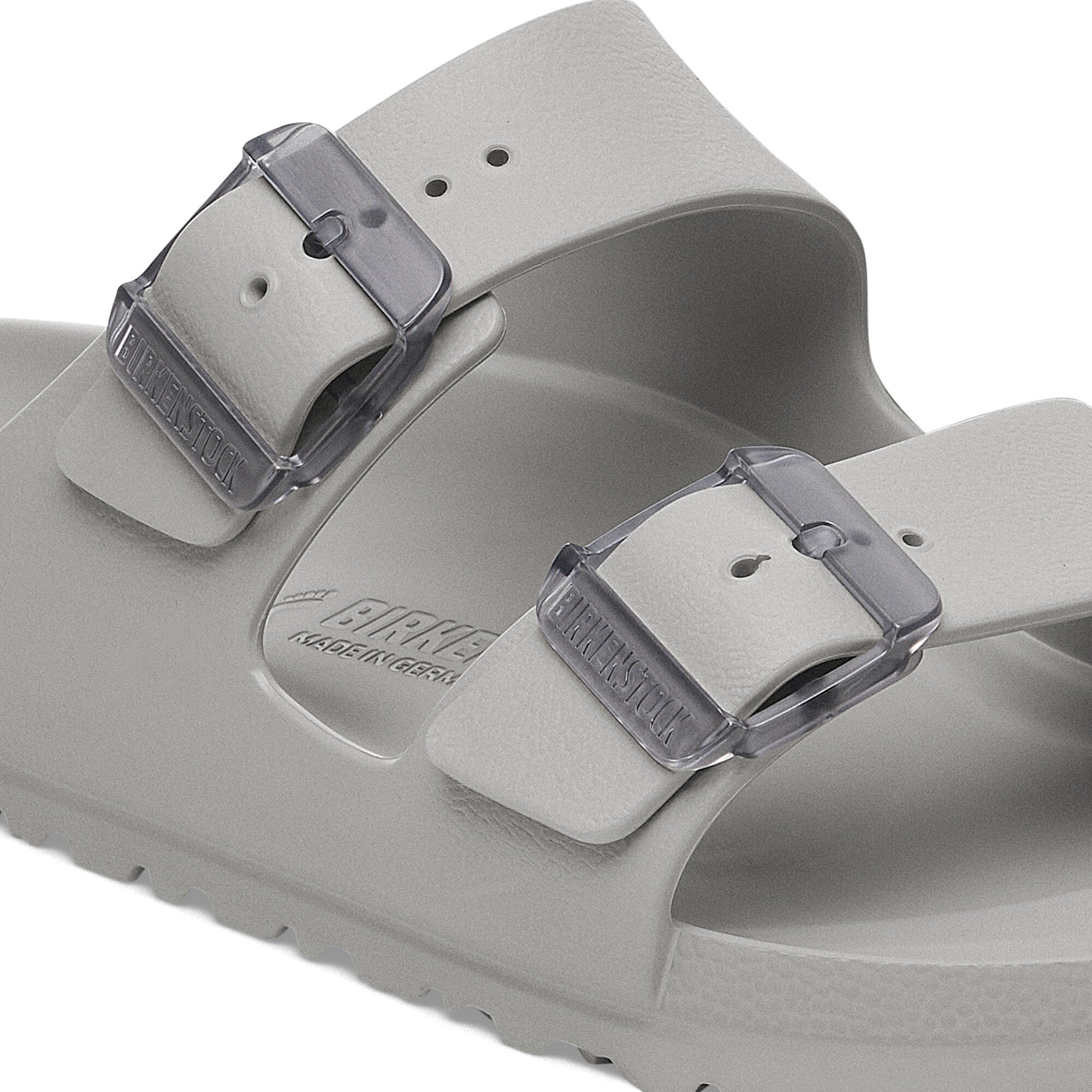 Close-up of Birkenstock Arizona Essentials sandal in Stone Coin with translucent buckles and water-friendly design.