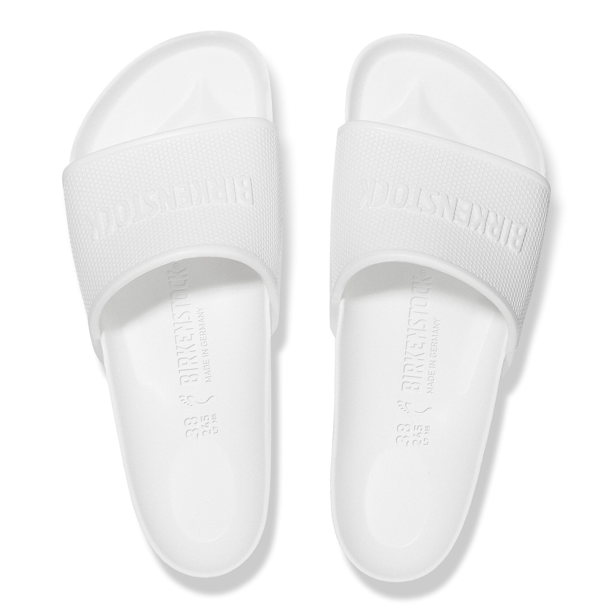 Birkenstock Barbados Essentials EVA slides in white, featuring a lightweight design with a contoured footbed for comfort.