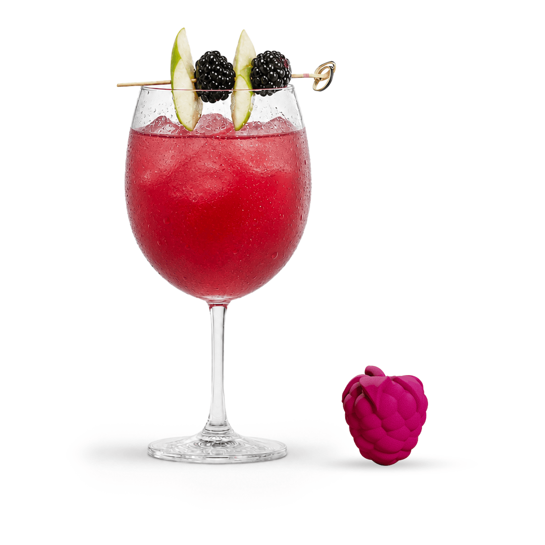 Red mocktail mix in a wine glass with raspberry flavor bomb on a white background