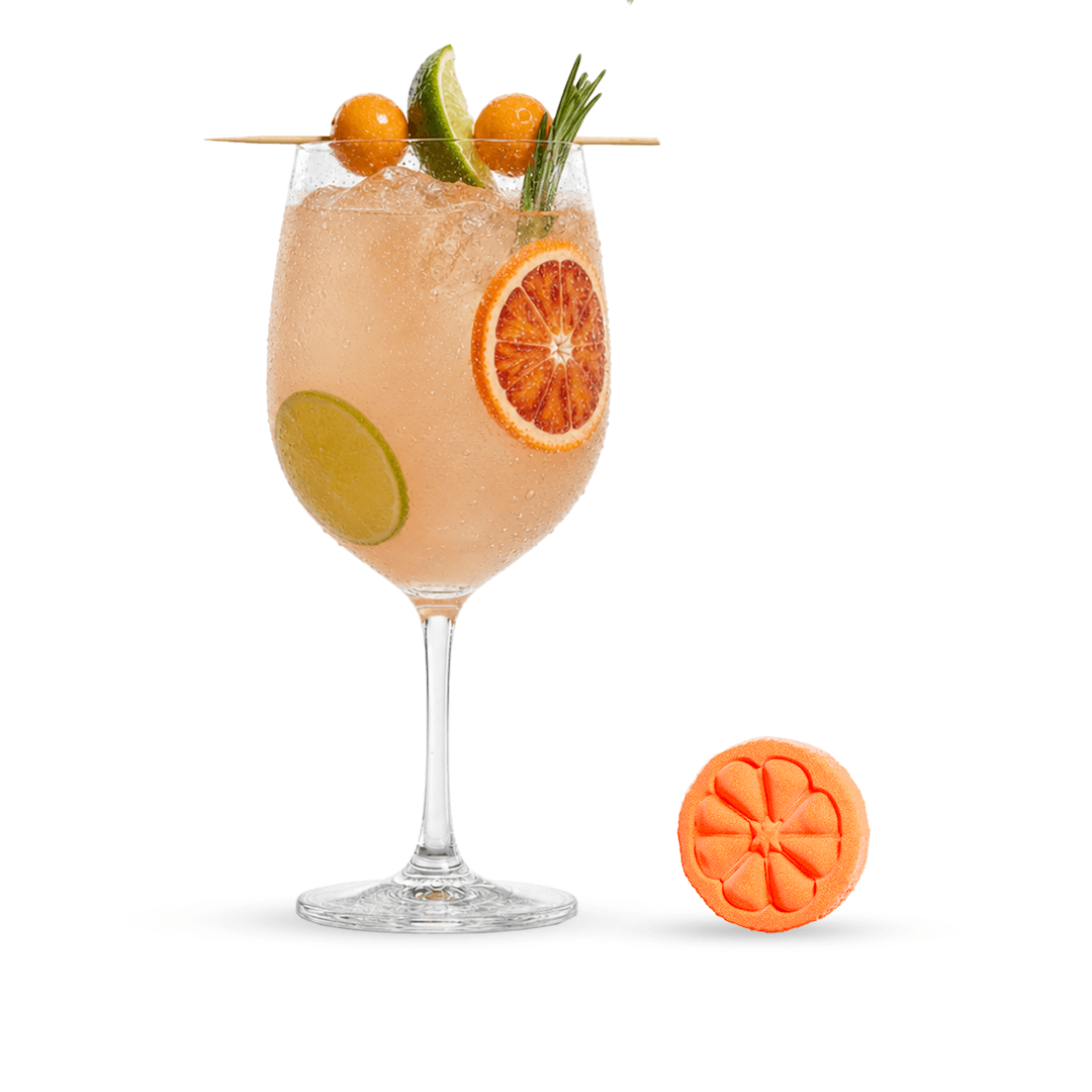Poseidn Cocktail flavors in a wine glass with fruit garnishes and a matching orange silicone coaster on a white background