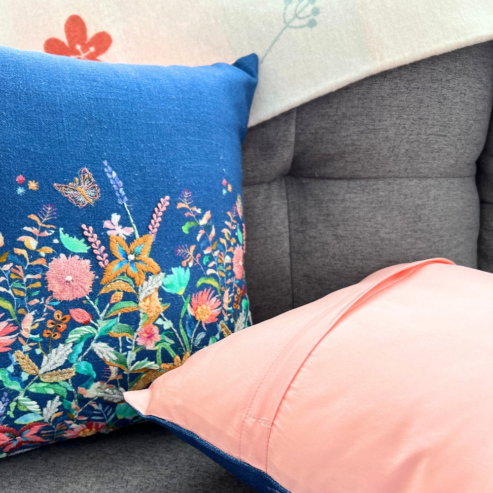 Decorative pillows with floral embroidery on a gray sofa