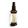 Brown bottle of Satin Reserve Body Oil with a white label on a white background