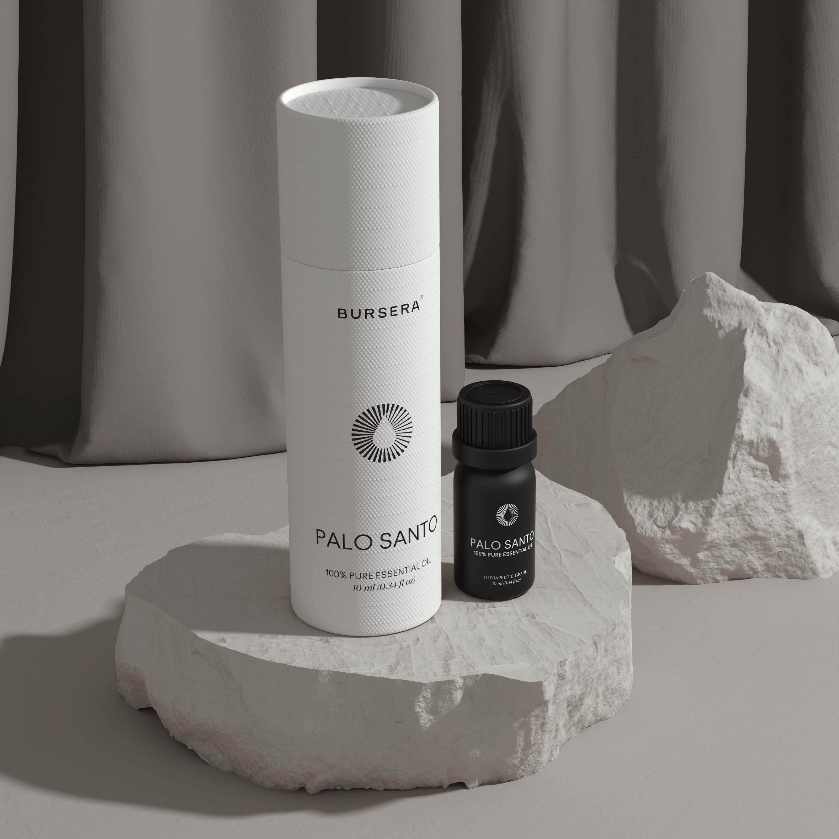 Two bottles of BURBERRA Palo Santo on a stone surface with a neutral background