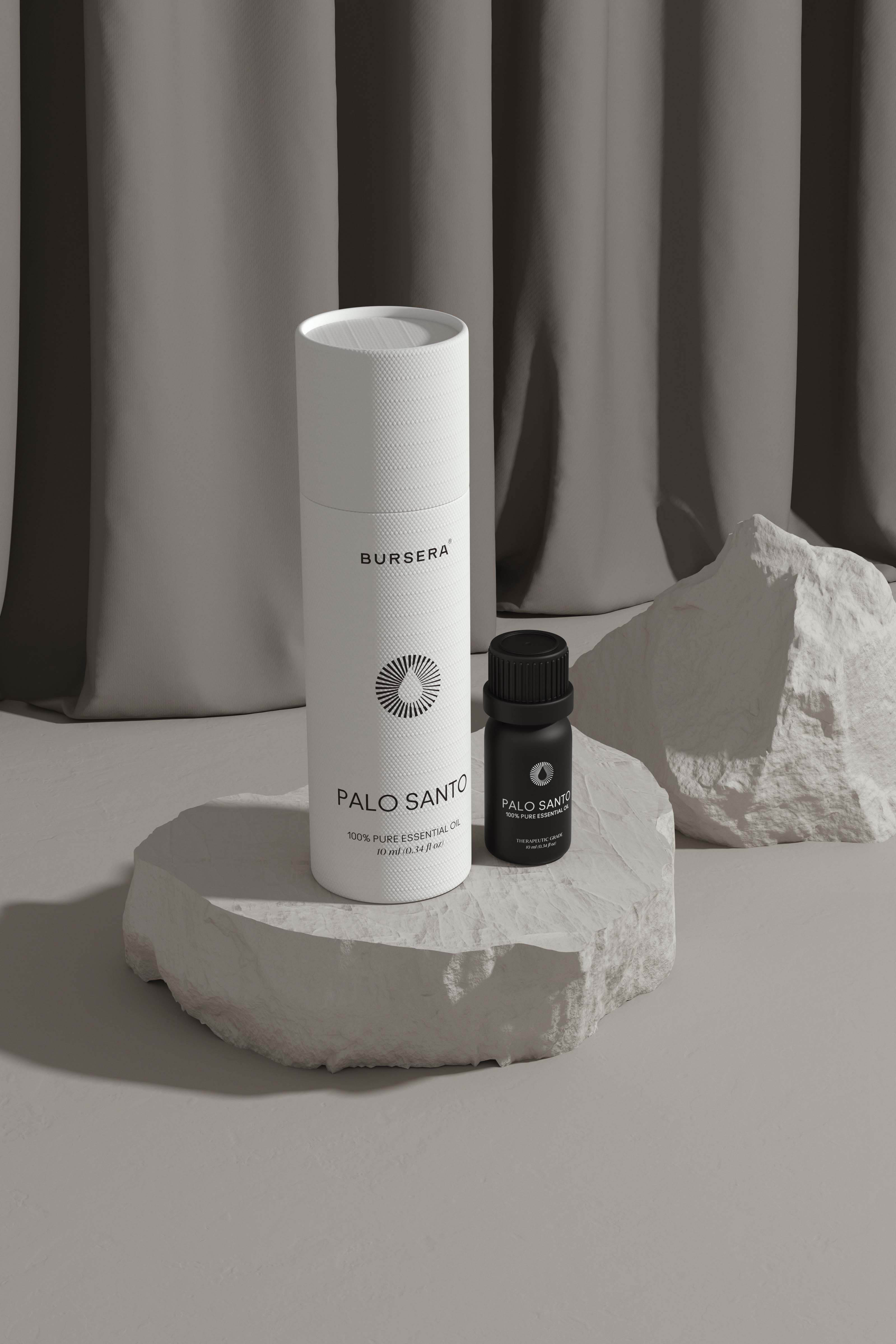 Two bottles of BURBERRA Palo Santo on a stone surface with a neutral background