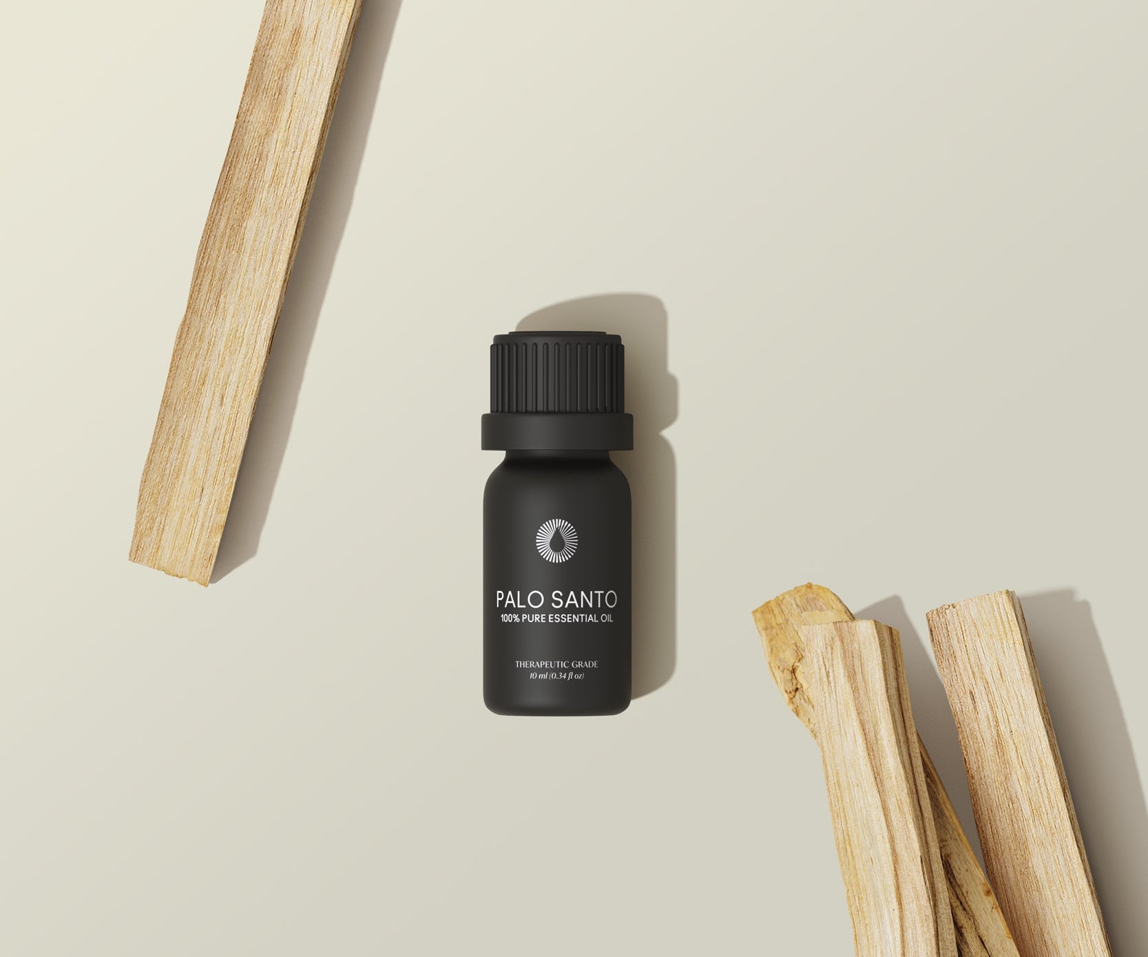 Palo Santo oil bottle with wooden sticks on a beige background