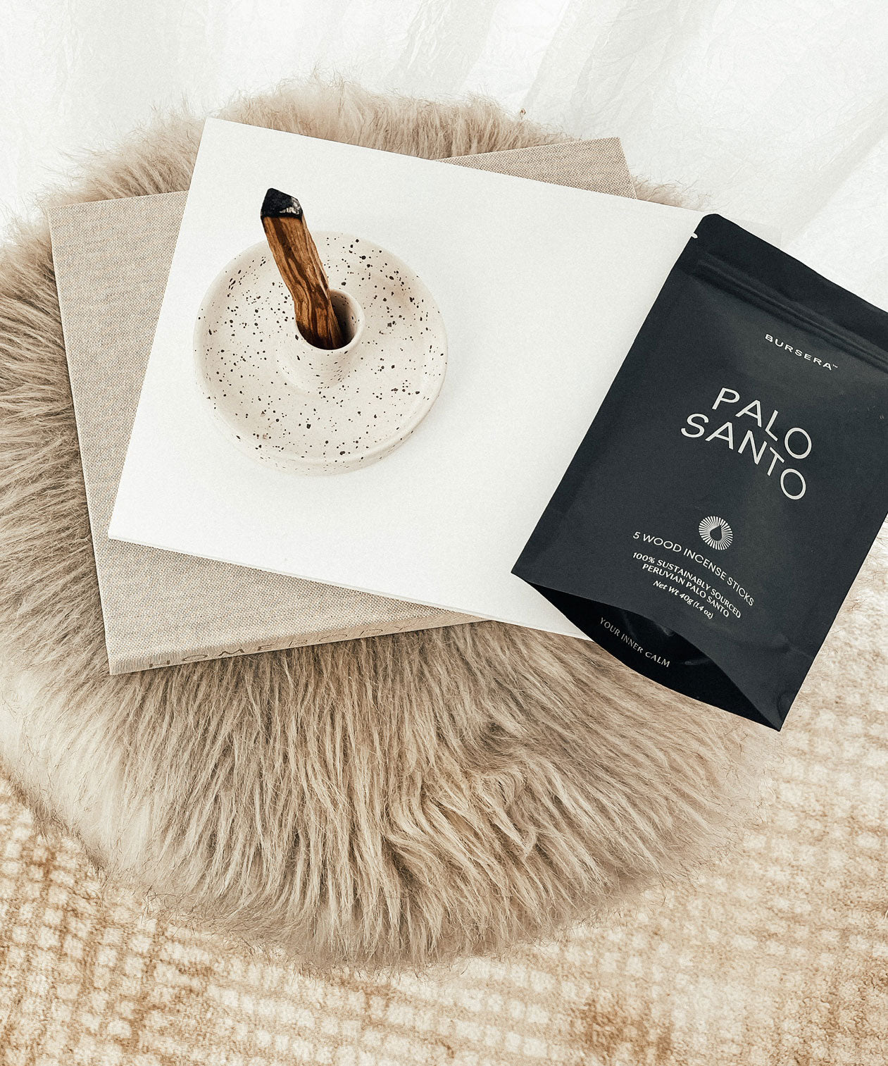 Palo Santo incense stick and packaging on a textured surface