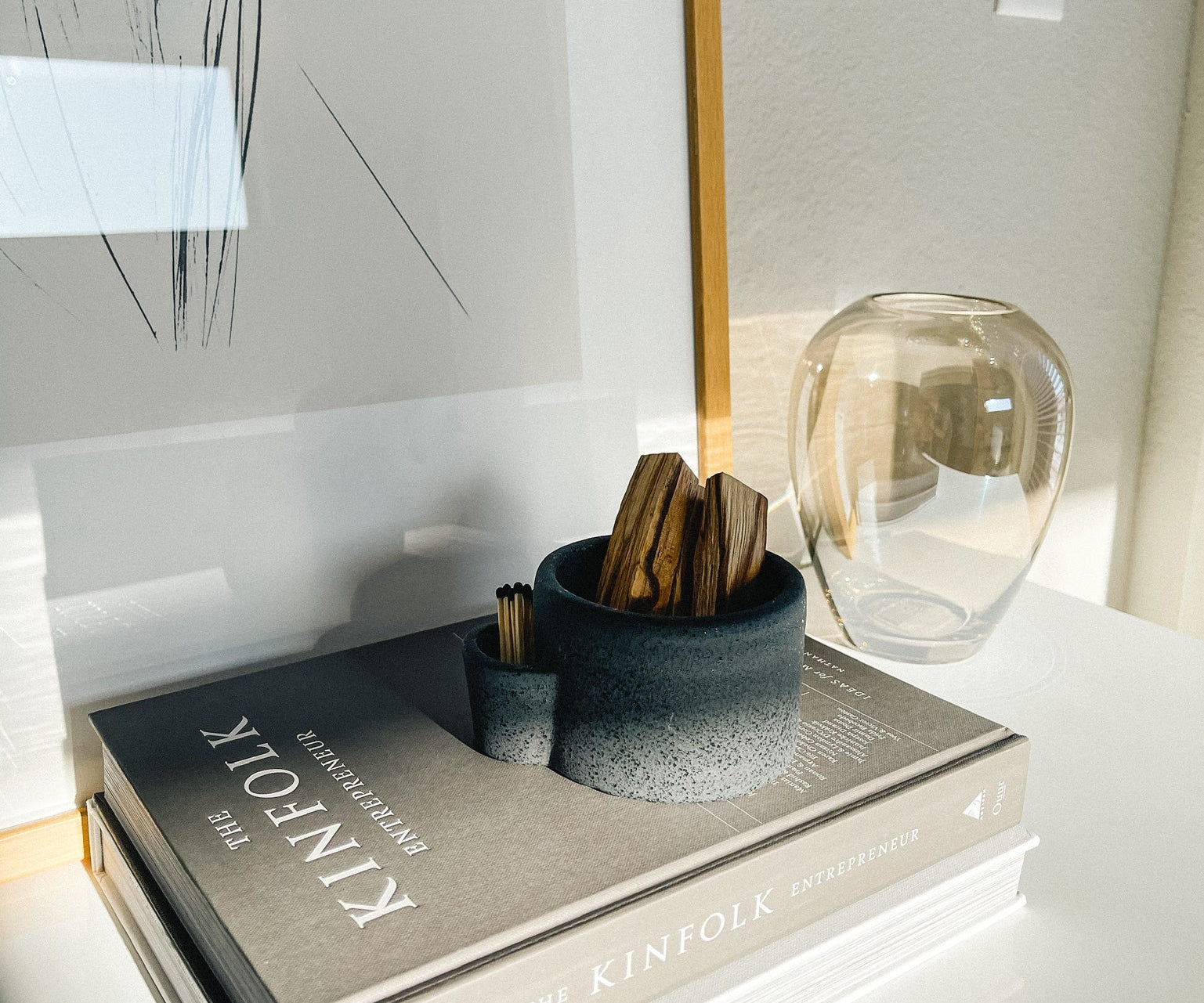 Decorative book with a vase and small container on a surface