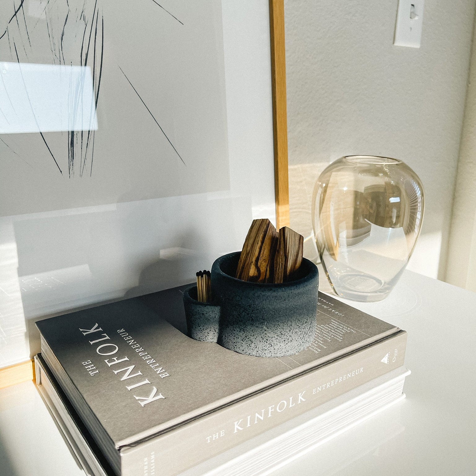 Decorative book with a vase and small container on a surface