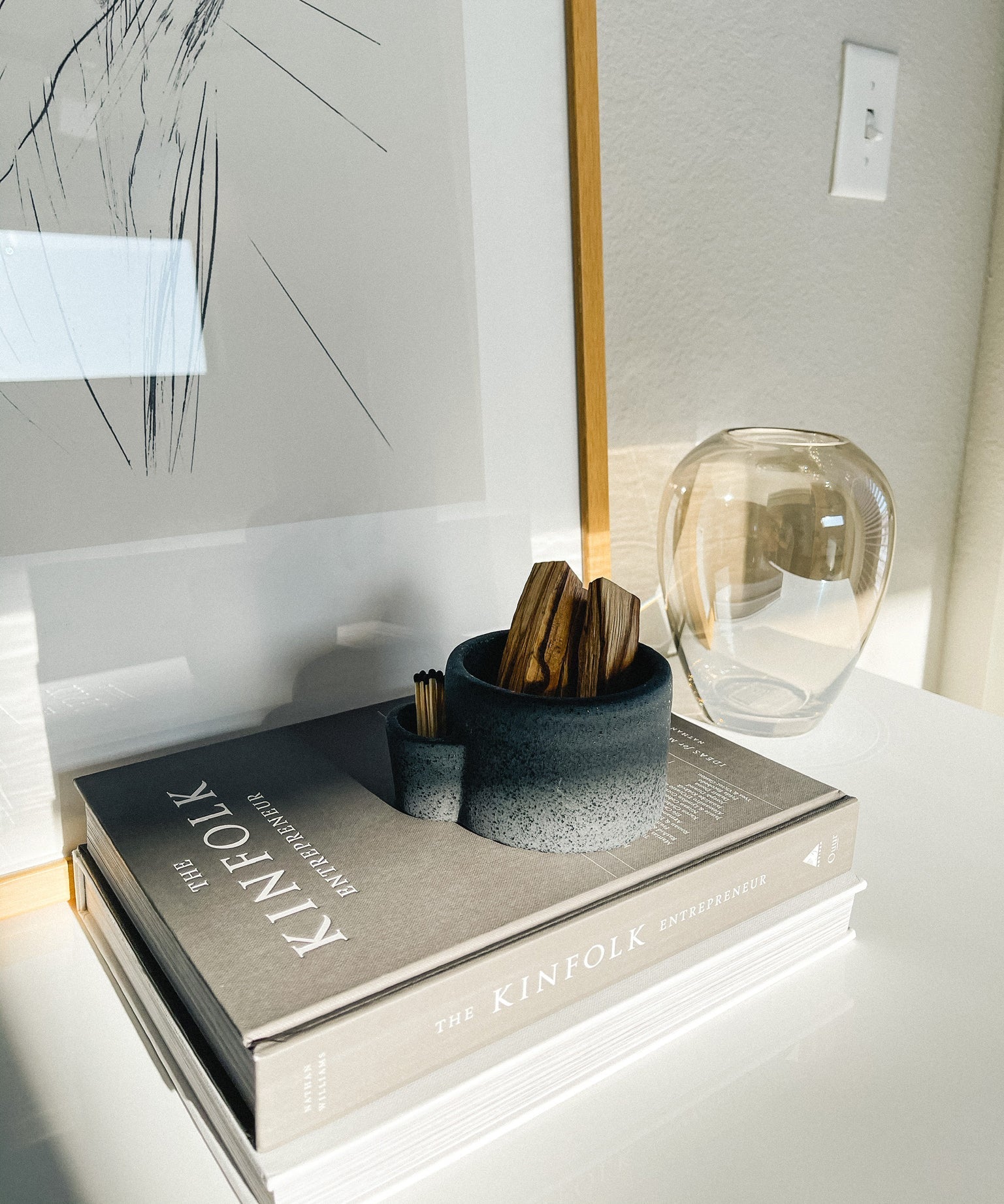 Decorative book with a vase and small container on a surface