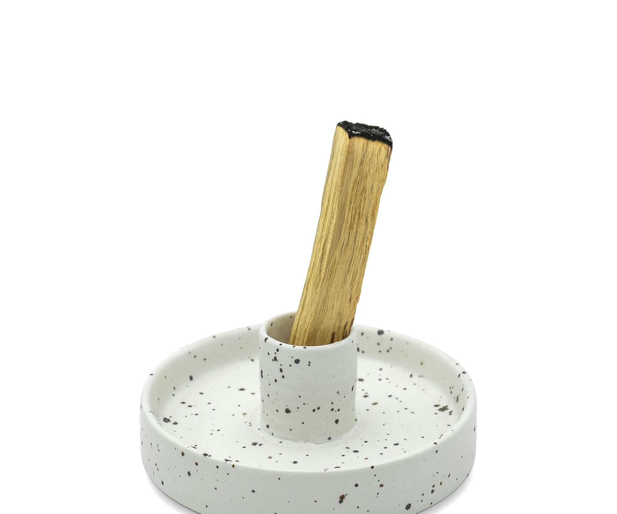 Speckled ceramic holder with a wooden stick on a white background