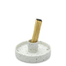 Speckled ceramic holder with a wooden stick on a white background