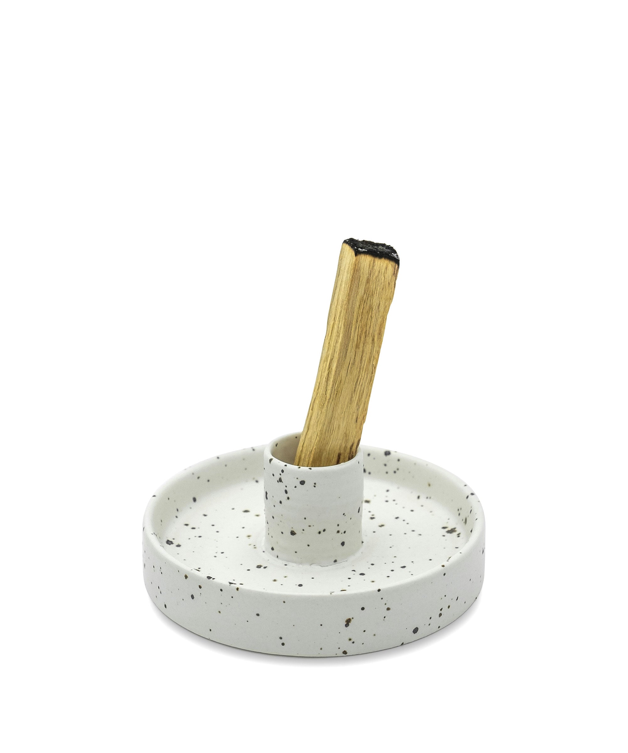 Speckled ceramic holder with a wooden stick on a white background