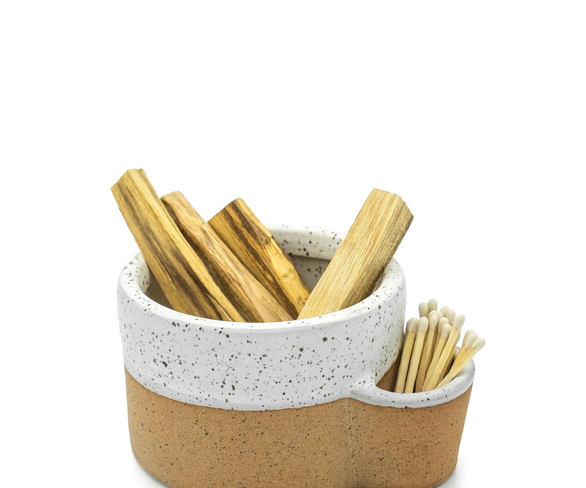 Ceramic holder with wooden sticks on a white background