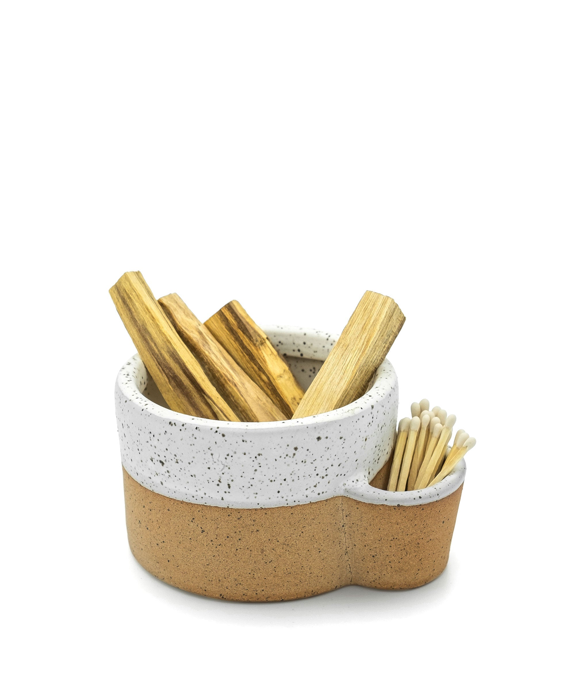 Ceramic holder with wooden sticks on a white background