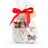 Gift set with a mug, cookies, and a red ribbon on a white background