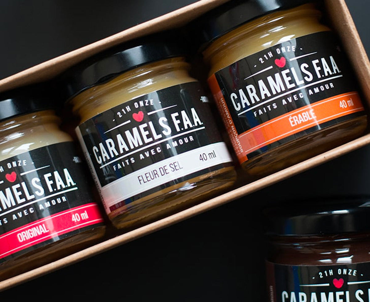 Three jars of Caramels Faar on a black surface with a box.