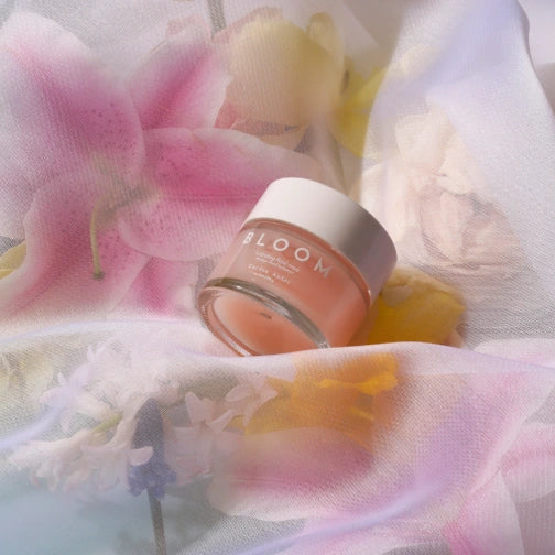 Cardea AuSet Bloom Jar surrounded by flowers on a soft fabric background