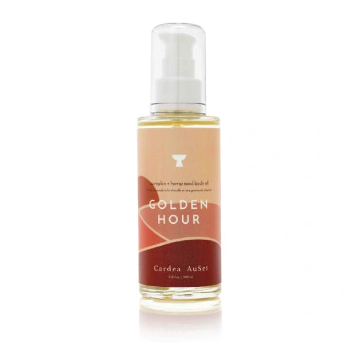Bottle of 'Golden Hour' body oil on a white background