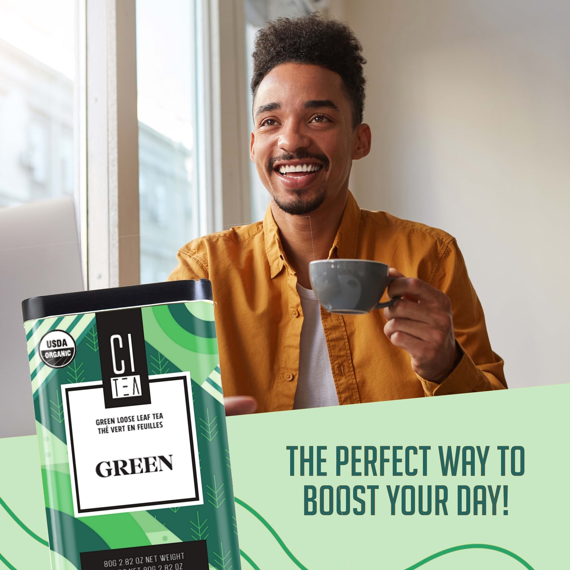 Man holding a cup with a green tea package and text about boosting your day.