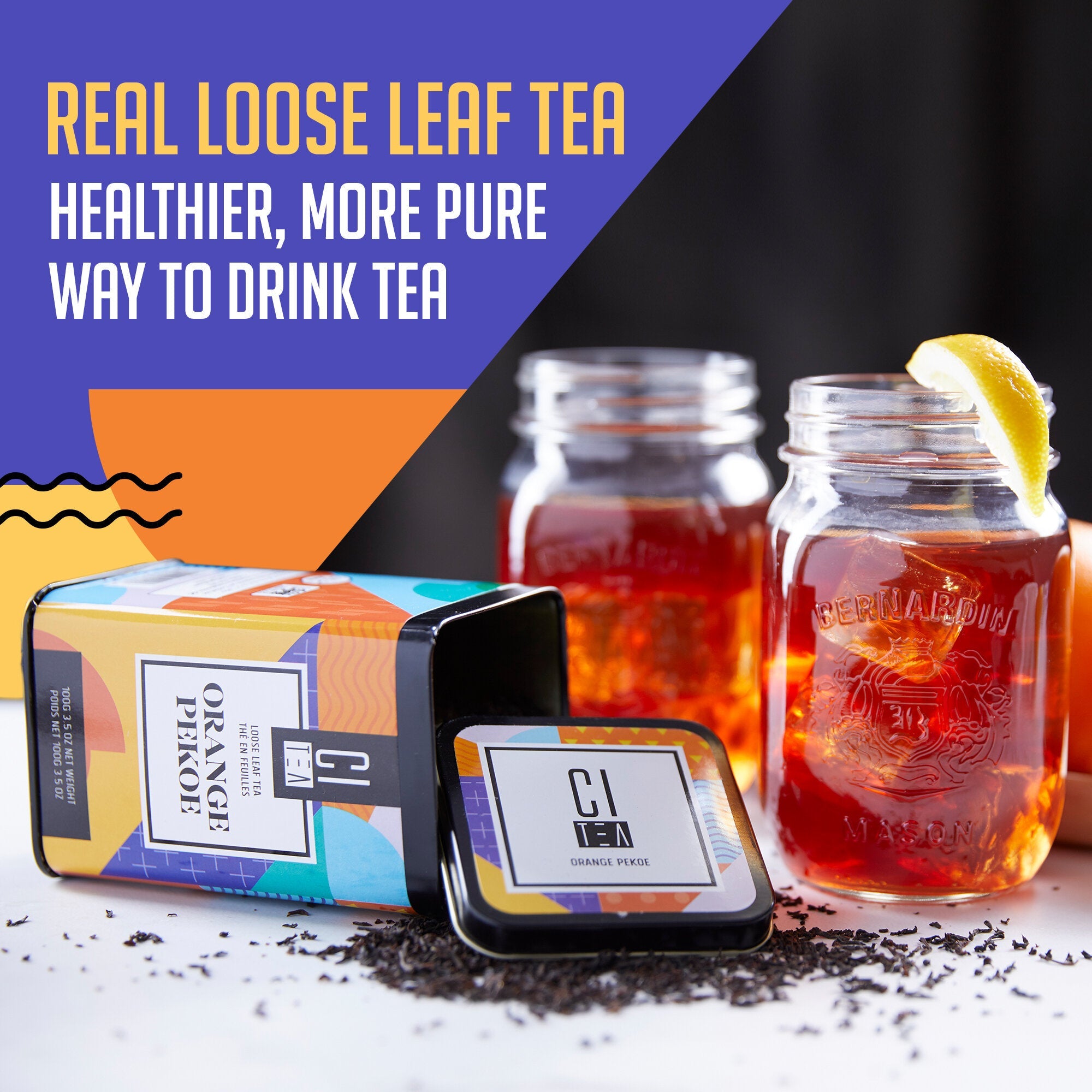 Real loose leaf tea packaging with two jars of tea and a lemon wedge on a dark background.