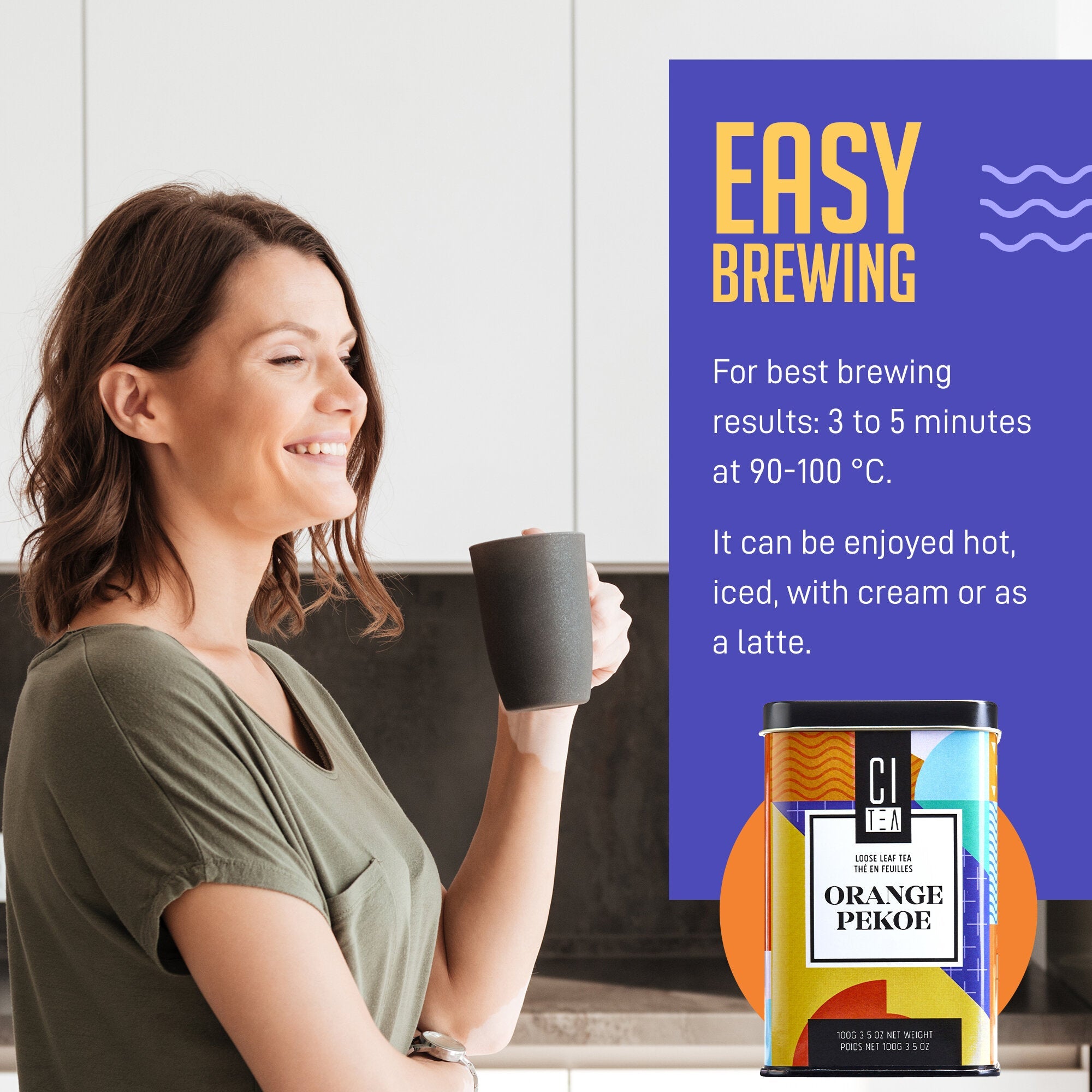 Woman holding a mug with a can of 'Orange Pekoe' tea and brewing instructions on a kitchen counter.
