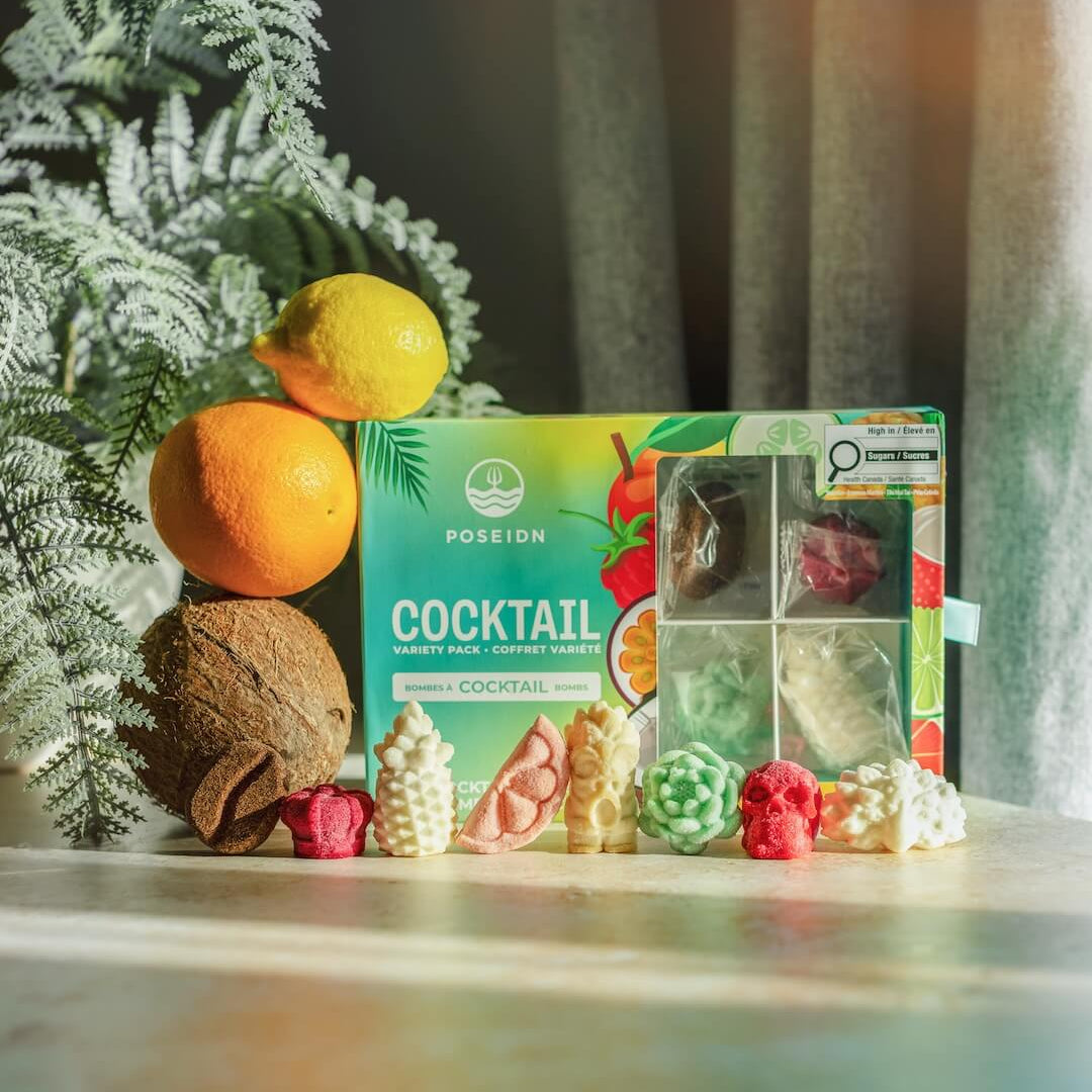 Poseidn Cocktail Variety Pack with cocktail bombs on a surface with a plant in the background.