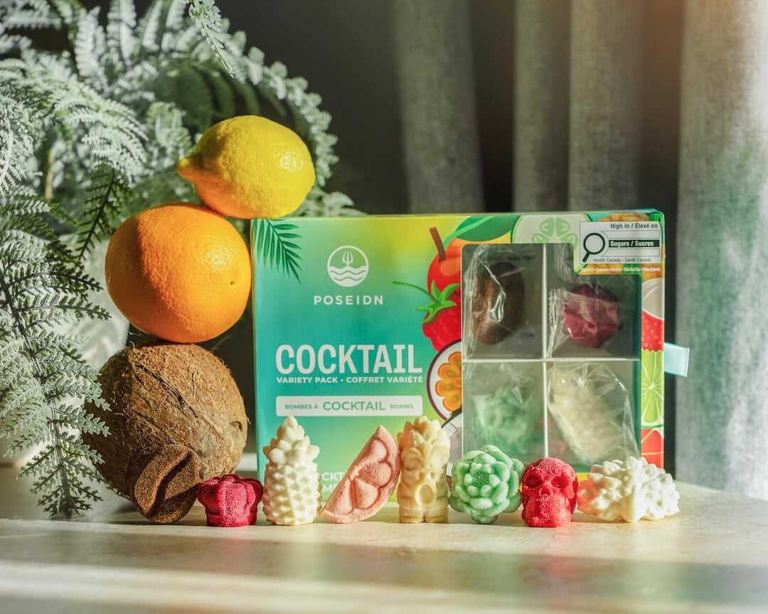 Poseidn Cocktail Variety Pack with cocktail bombs on a surface with a plant in the background.