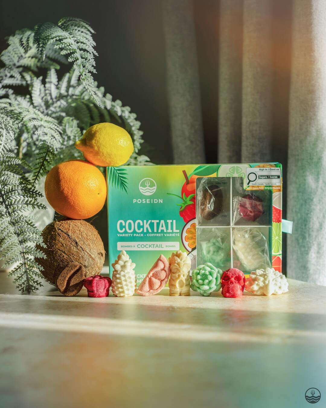 Poseidn Cocktail Variety Pack with cocktail bombs on a surface with a plant in the background.