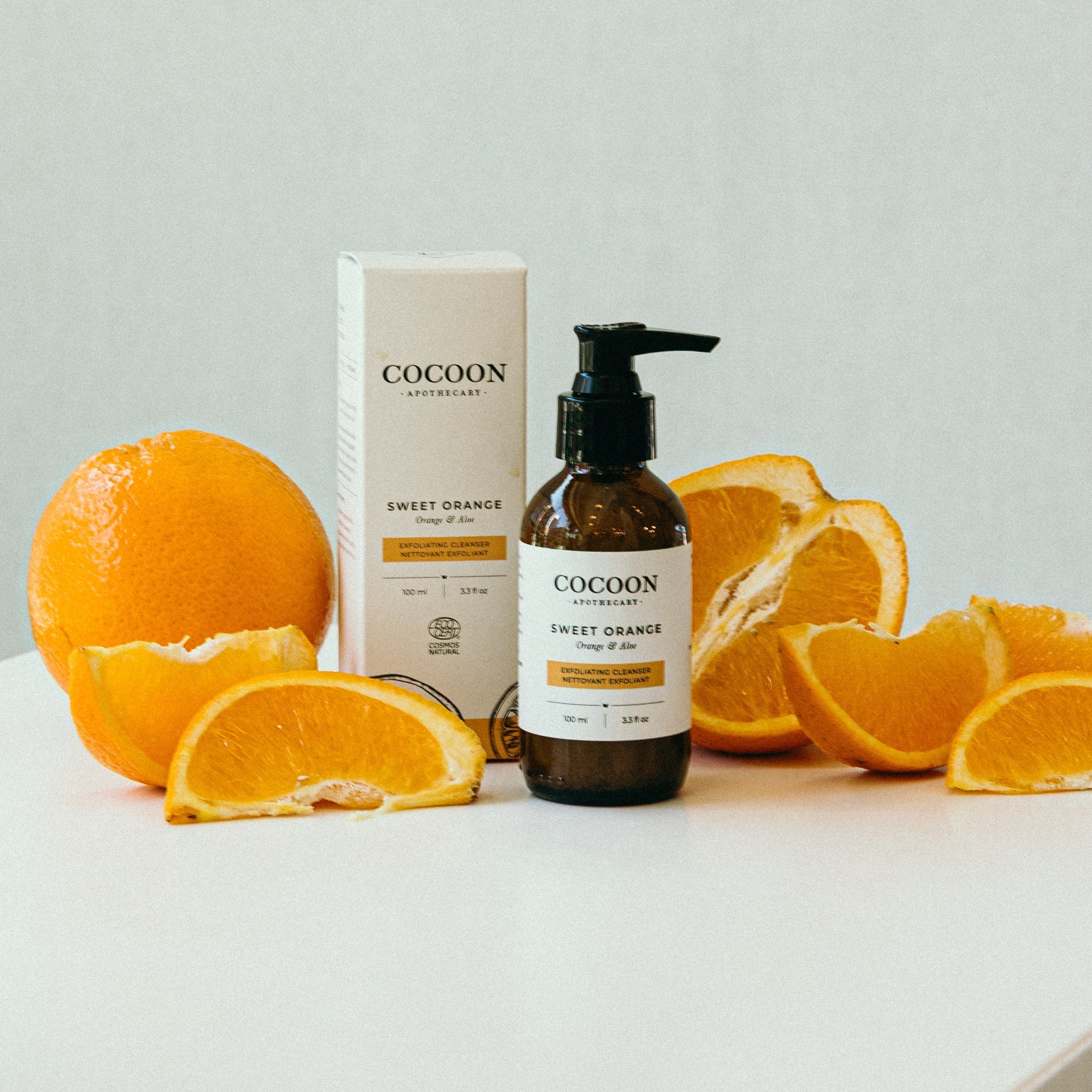 Cocoon Sweet Orange product with oranges on a light background