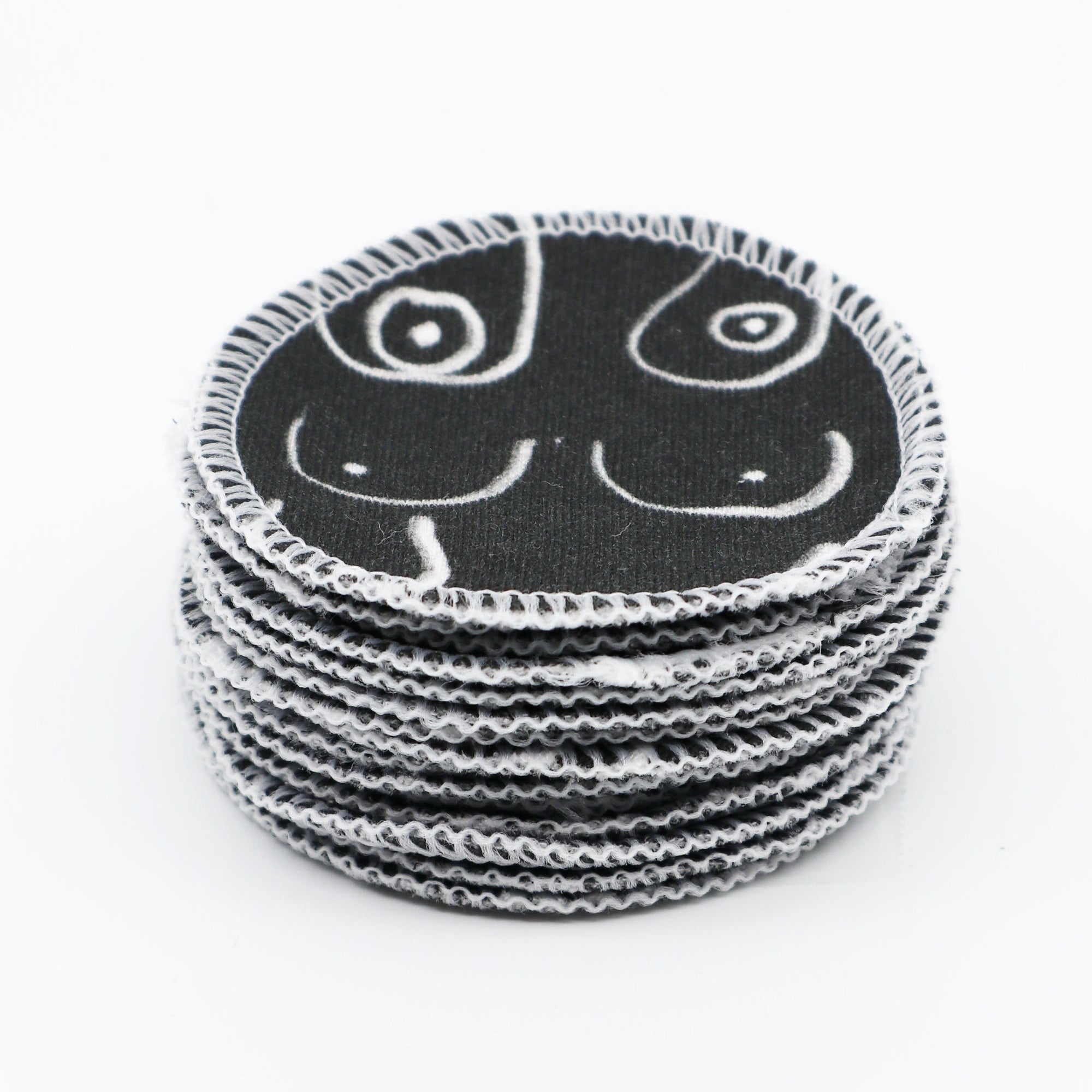 Black and white resuable cotton makeup pads on a white cloth by Freon Collective stacked 2