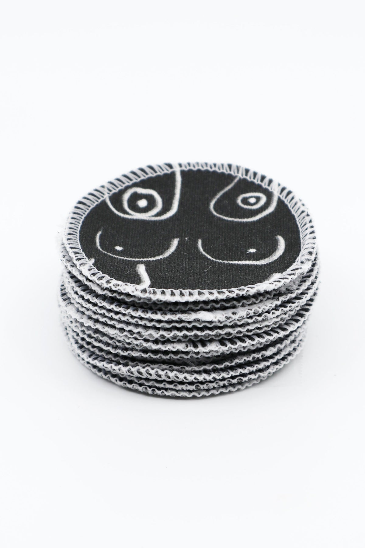 Black and white resuable cotton makeup pads on a white cloth by Freon Collective stacked 2