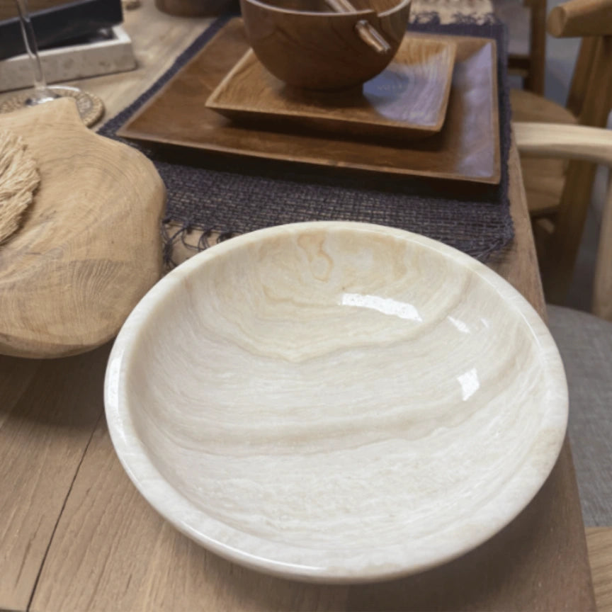White onyx bowl on a wooden table with a blurred background