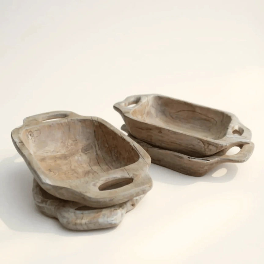 Set of wooden serving trays with handles on a light background