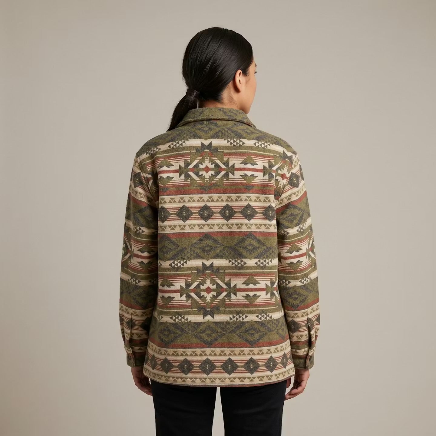 Person wearing a patterned jacket on a plain background OldTribes