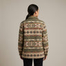 Person wearing a patterned jacket on a plain background OldTribes