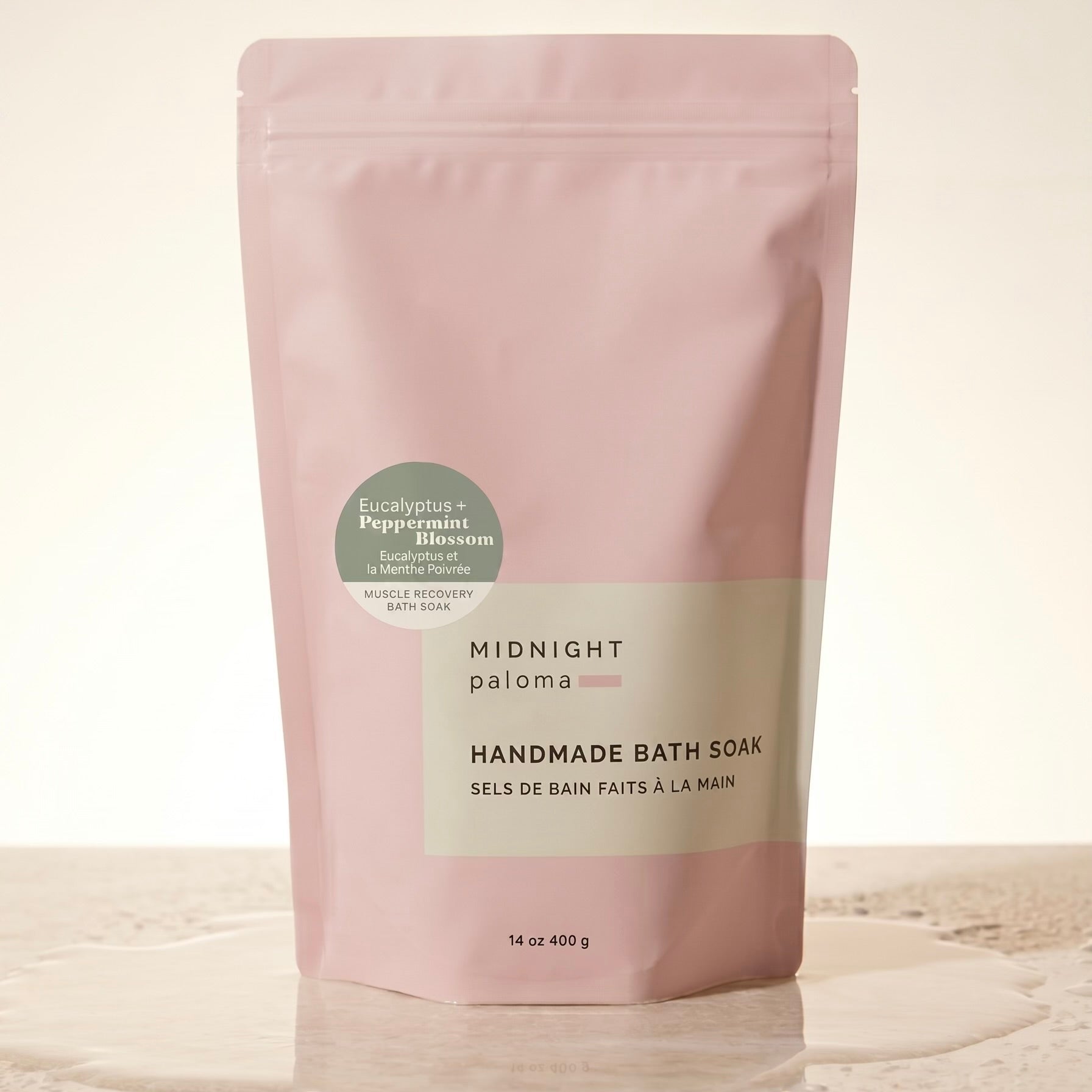 Handmade bath soak packaging with pink and beige design on a light background