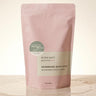 Handmade bath soak packaging with pink and beige design on a light background