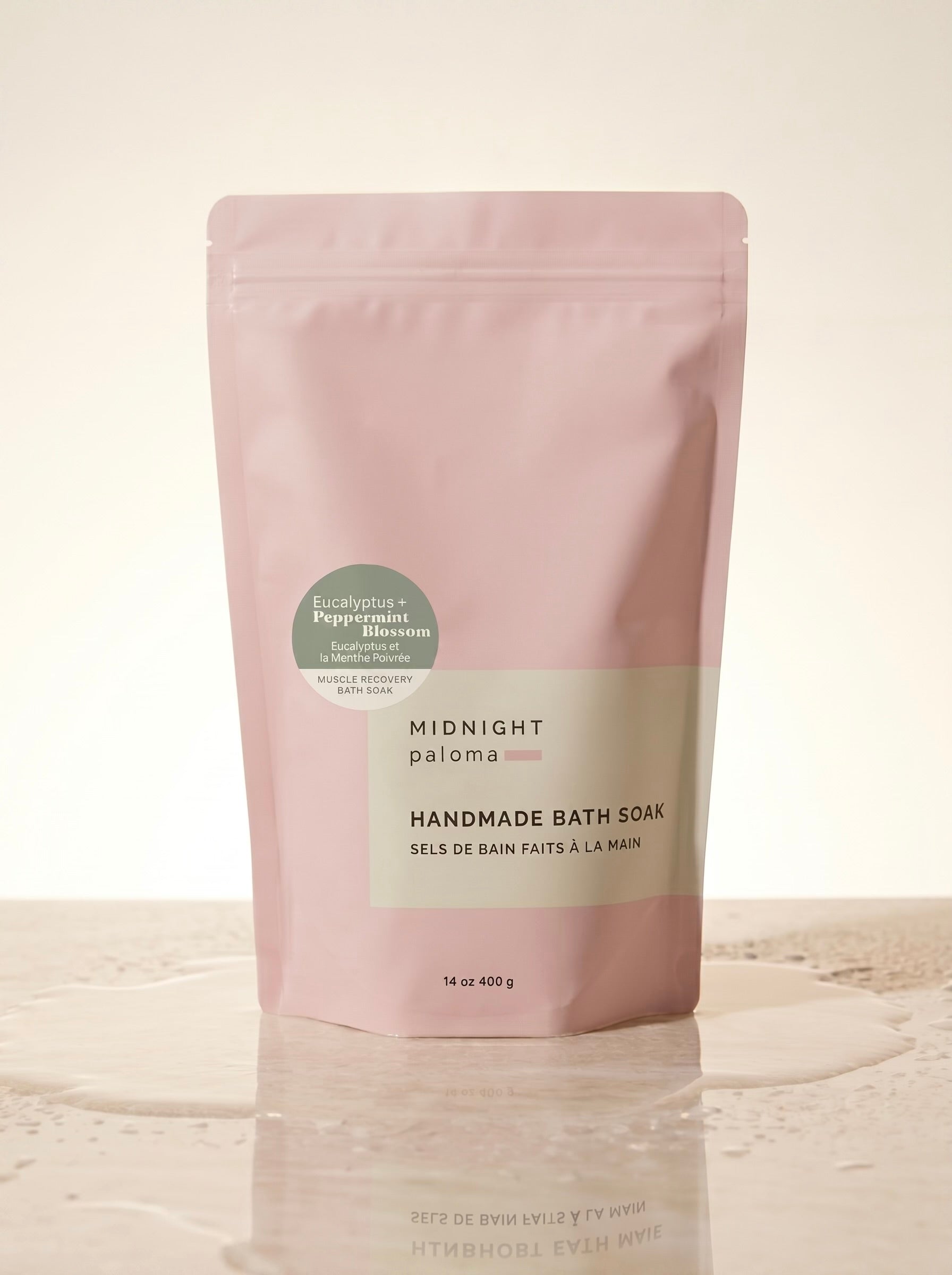 Handmade bath soak packaging with pink and beige design on a light background