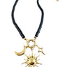 Moonrise Necklace - Onyx with gold sun, moon, and star charms on a black beaded chain against a white background