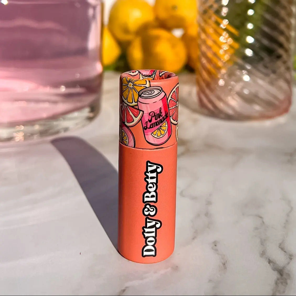 Lip balm with colorful packaging on a marble surface