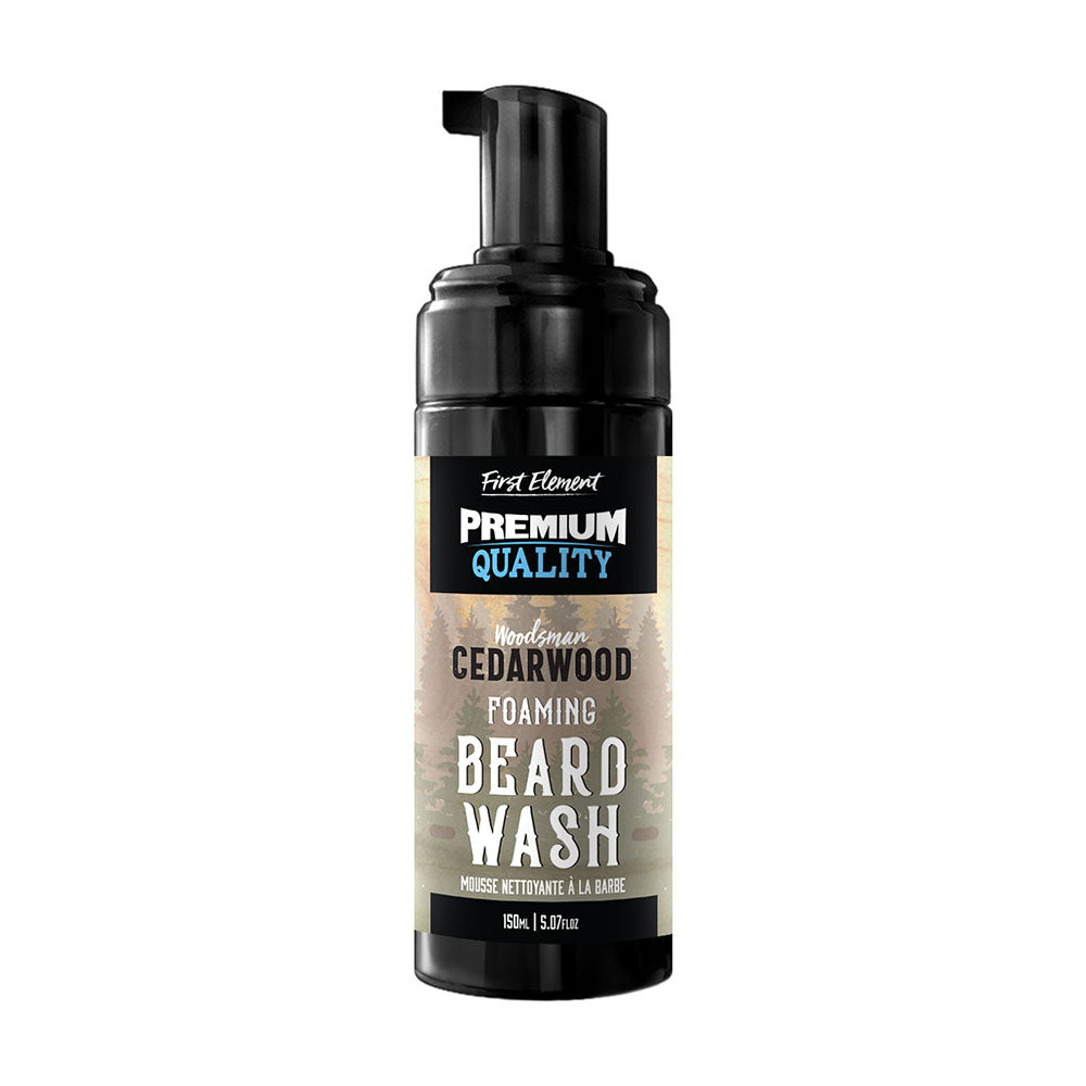 A bottle of First Element Beard Wash in Cedarwood scent, featuring a black pump dispenser and a label with a rustic wood-grain pattern on a white background.