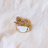 Floral cup pin on a white fabric background mimi-and-august