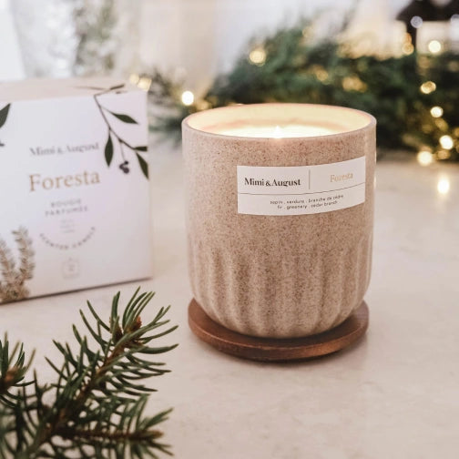 Candle with 'Mimi & August' label on a surface with decorative elements Foresta Reusable Candle by mimi and august