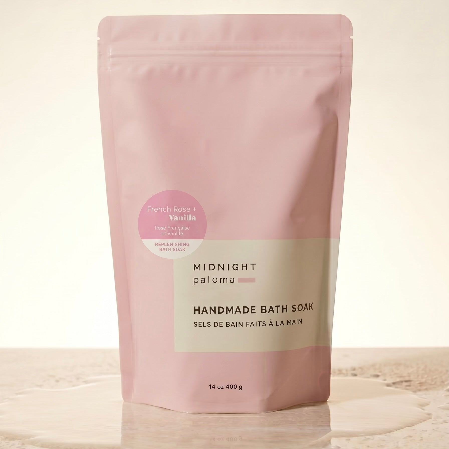 Pink packaging of handmade bath soak on a beige background