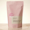 Pink packaging of handmade bath soak on a beige background